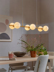 Suspension luminaire linéaire Carrara 6 globes en effet marbre blanc et doré